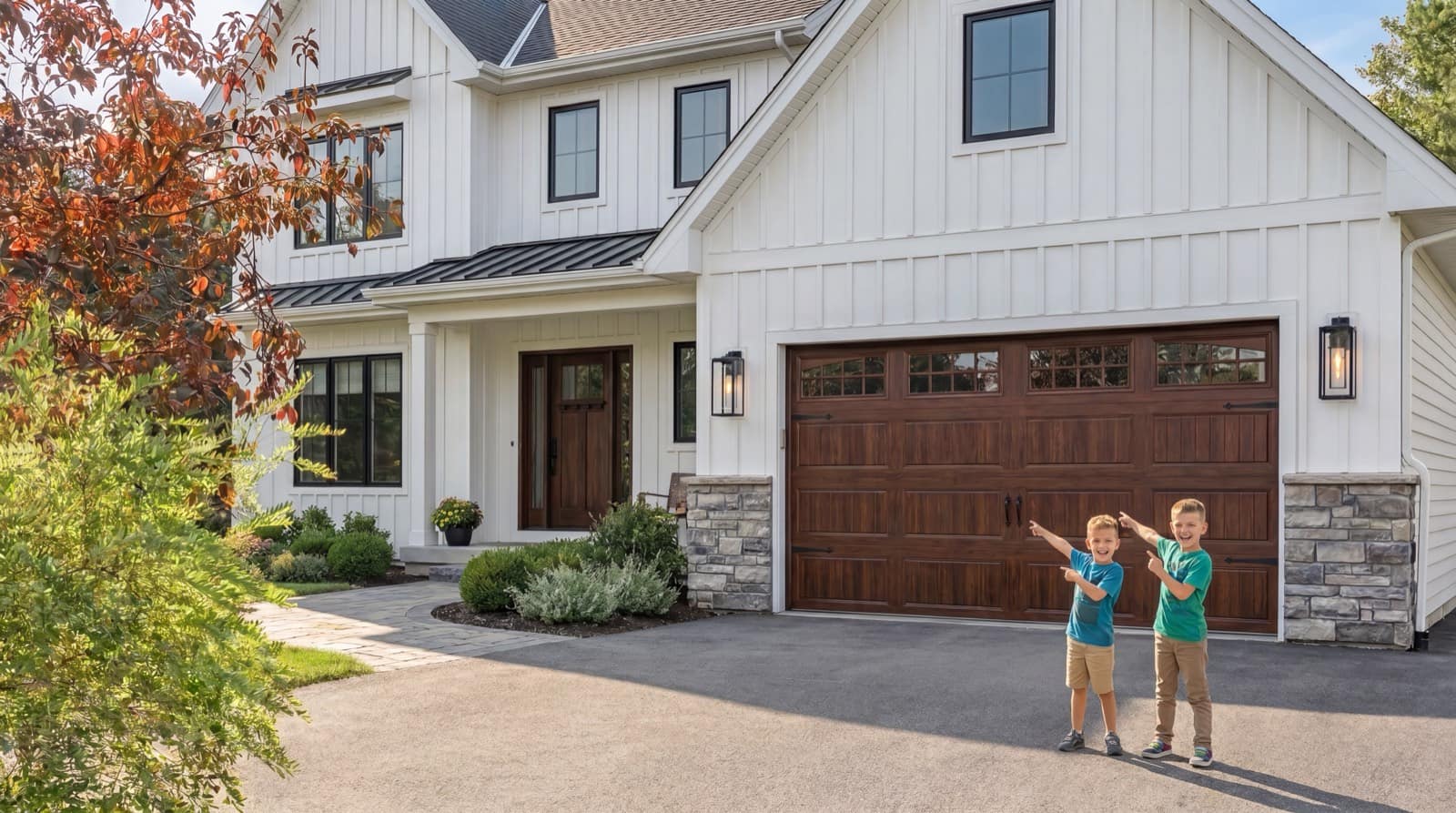 A modern white farmhouse home with a rich wood-finish double garage door on a sunny driveway, two kids pointing up at the new door
